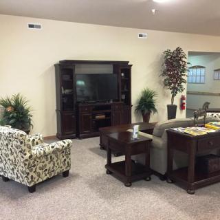 A cozy living room with comfortable seating and a television unit.