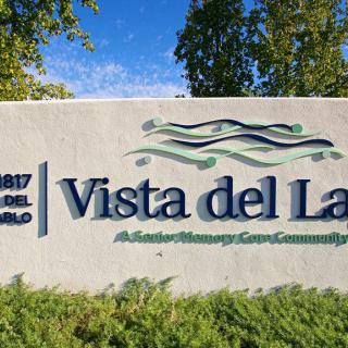 Sign for Vista del Lago, an assisted memory care community.