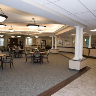 A spacious and elegantly designed lobby and dining area with comfortable seating arrangements.