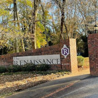 The entrance to a community or property named 'Renaissance' surrounded by lush trees.