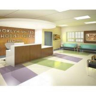 A modern hospital reception and waiting area with comfortable seating.