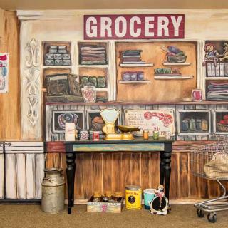 A vintage grocery mural featuring shelves, a scale, and retro decor.