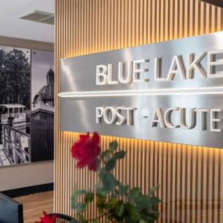 Interior view of Blue Lake Post-Acute facility with a decorative sign and flowers.