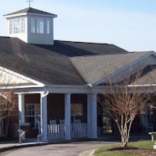 A welcoming residential building with a classic design and a charming front porch.