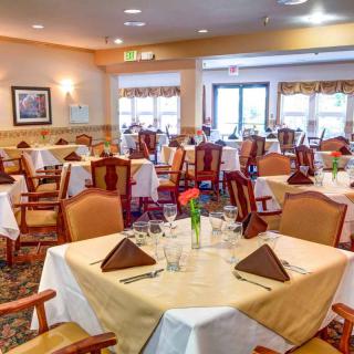 An elegant dining room with neatly arranged tables and chairs, ready for guests.