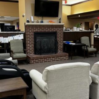A cozy lobby area with a brick fireplace and comfortable seating.