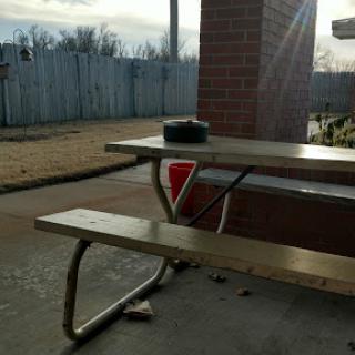 A solitary picnic table basking in the warm sunlight on a quiet day.