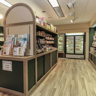 A well-organized store interior with shelves stocked with various products and a wooden floor.
