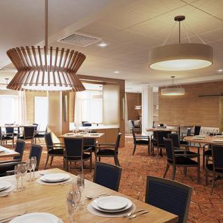 An elegantly designed restaurant dining room with neatly arranged tables and modern lighting.