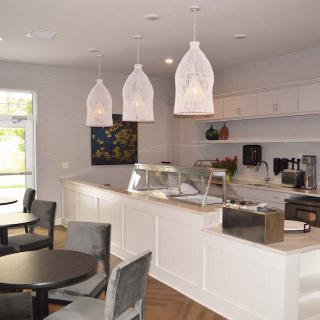 A modern cafe interior with pendant lighting and a sleek, minimalist design.