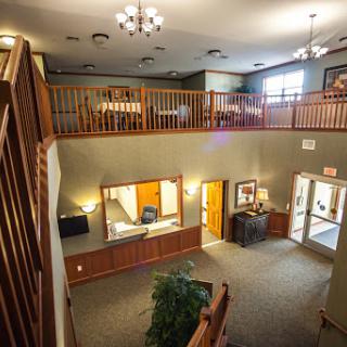 A spacious and well-lit lobby area featuring a reception desk and comfortable seating.