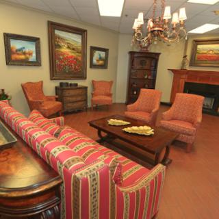 A cozy living room setup featuring comfortable seating and decorative artwork.