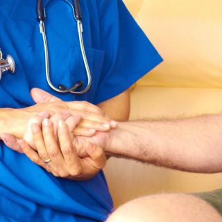 A healthcare professional providing comforting support to a patient.