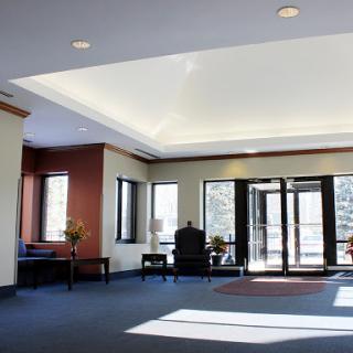 A spacious and modern lobby area with large windows allowing natural light to illuminate the space.