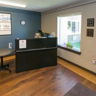 An empty office reception area with a desk and window.