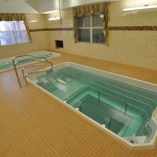 An indoor therapy pool designed for hydrotherapy and rehabilitation exercises.
