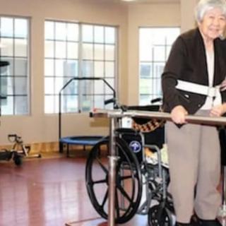 An elderly person using a walker in a rehabilitation center.