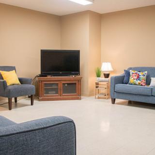 Cozy living room with comfortable seating and a television setup.