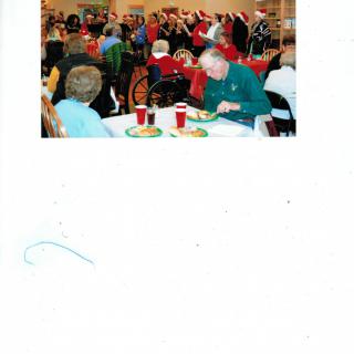 A festive gathering with seniors enjoying a holiday meal together.