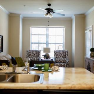 A modern open-concept kitchen and living room with a bright window view.