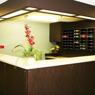 A reception desk with decorative flowers and mail slots in an office setting.