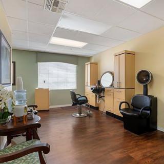 A well-organized hair salon with styling stations and comfortable seating.