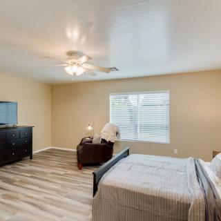 A modern bedroom with wood flooring and simple decor.