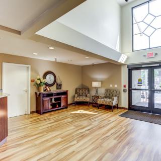 A modern lobby area with a reception desk and comfortable seating.