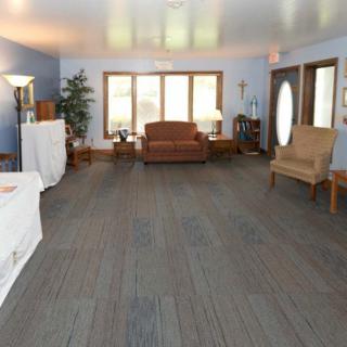 A cozy living room with comfortable seating and natural light from large windows.