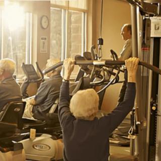 Seniors engaged in a fitness session at the gym.