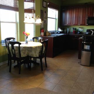 A cozy kitchen and dining area with natural light streaming through the windows.
