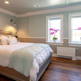 A serene and modern bedroom featuring soft color tones, natural light, and elegant decor.