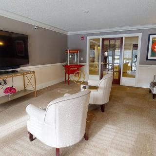 Cozy living room with comfortable seating, a large TV, and a popcorn machine for entertainment.