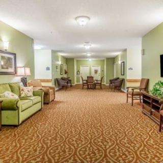 A spacious lobby area with comfortable seating and warm lighting.