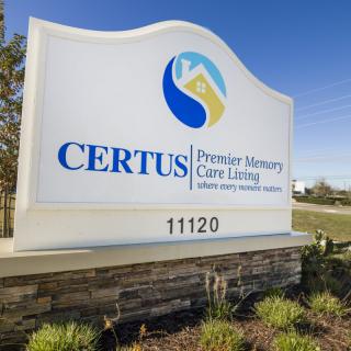 A sign for CERTUS Premier Memory Care Living located outdoors.