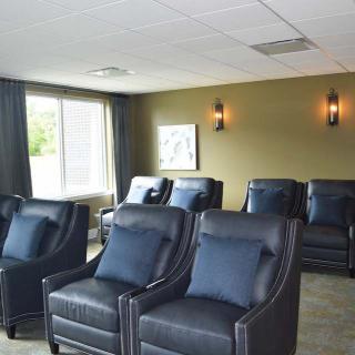A comfortable lounge area with rows of plush, reclining chairs in a well-lit room.