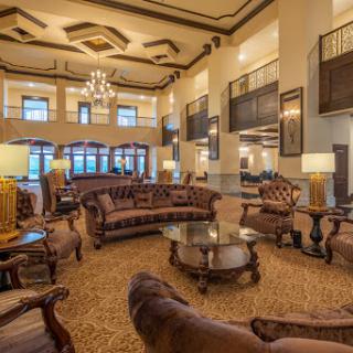 A spacious and elegantly designed hotel lobby featuring luxurious furniture and ambient lighting.