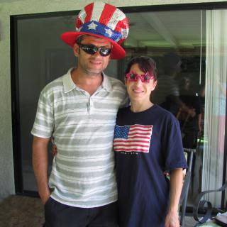 A couple dressed in patriotic attire with American-themed accessories.