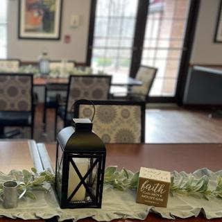 A cozy dining area adorned with decorative elements, including a lantern and a touch of greenery.