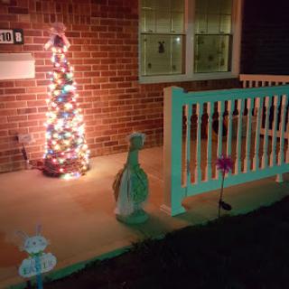 A festive front porch adorned with holiday lights and decorations.