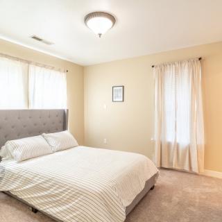 A minimalist bedroom with neutral colors and ample natural light.