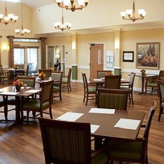 A well-lit dining area with tables and chairs arranged in a spacious setting.