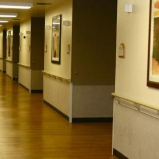 A well-lit hospital hallway with artwork on the walls.