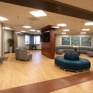 A modern and spacious waiting area featuring comfortable seating and a welcoming atmosphere.