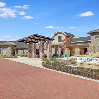 A modern building with an inviting entrance and landscaped surroundings.