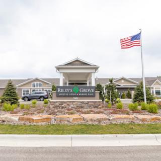 Welcome to the community center with American flag and landscaped grounds.