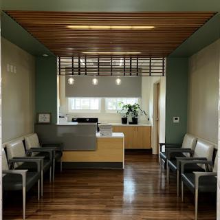 A modern waiting room featuring sleek furniture and a welcoming reception area.