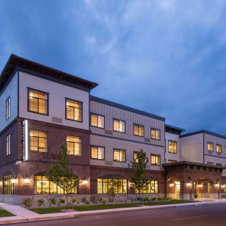 A modern building illuminated in the evening.