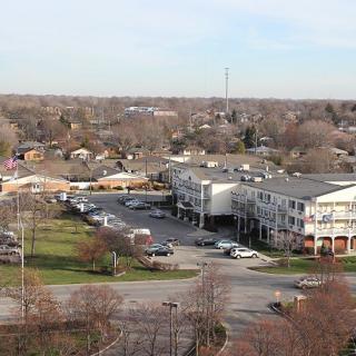 Aerial view of a suburban area with buildings and a parking lot.