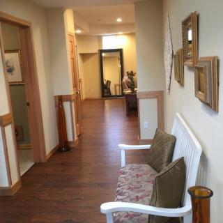 A cozy hallway with seating and wall decor.